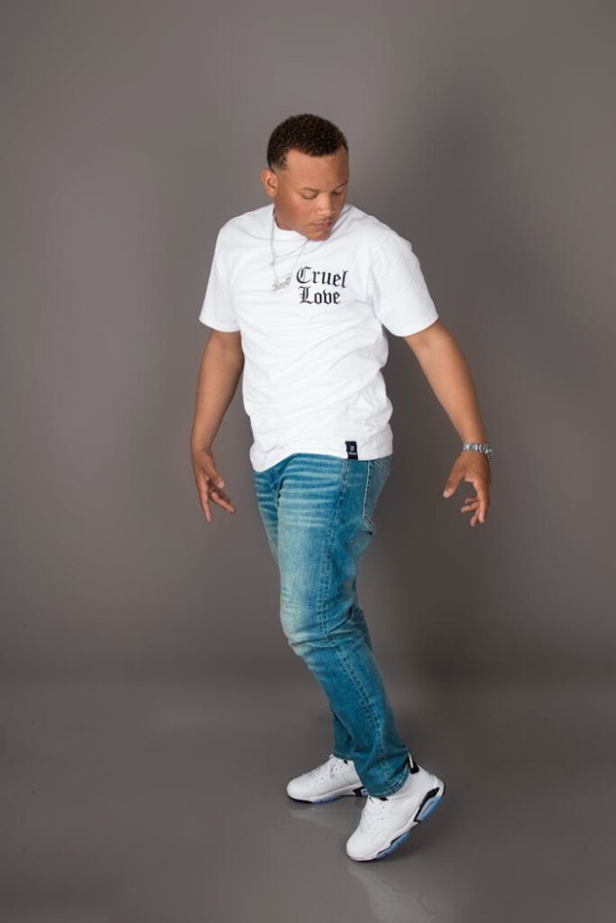 Studio portrait of a young Hispanic male in casual attire with 'Cruel Love' T-shirt, Puerto Plata.